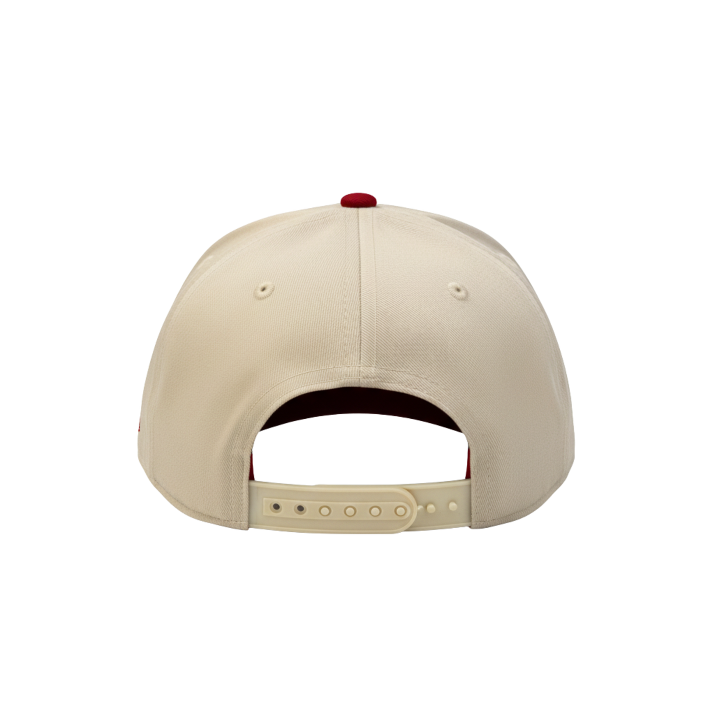 Back of a beige baseball cap with a red button on a white background